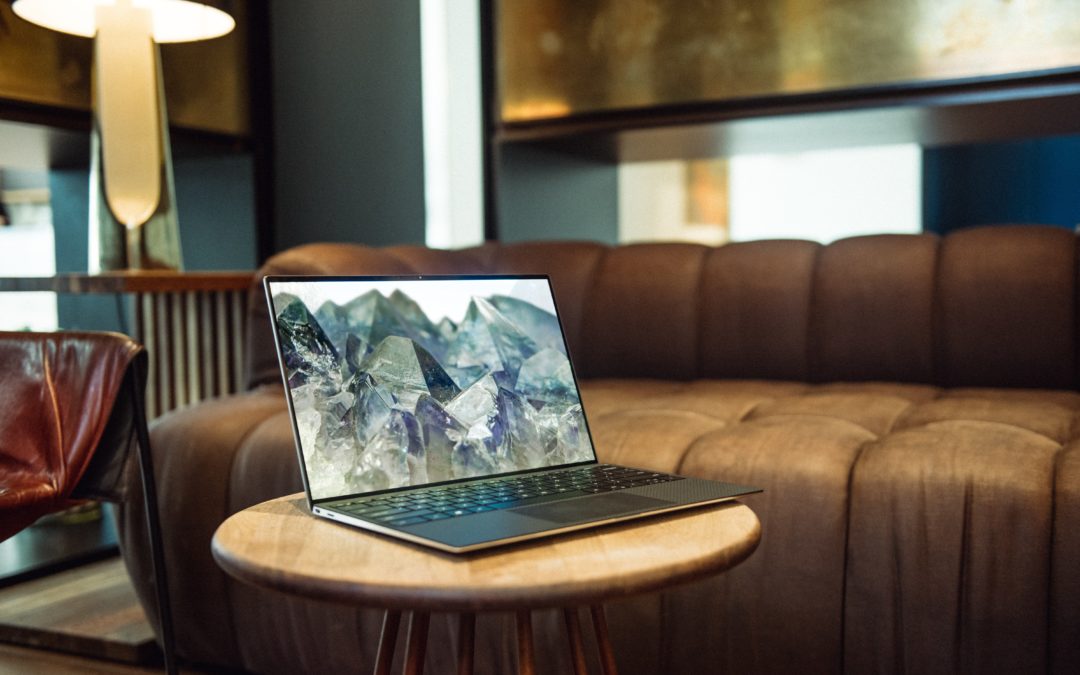 laptop on brown sofa